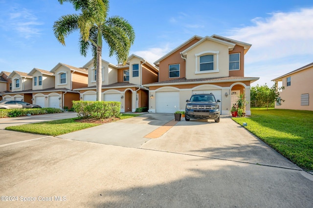 view of front of property featuring a front yard and a garage