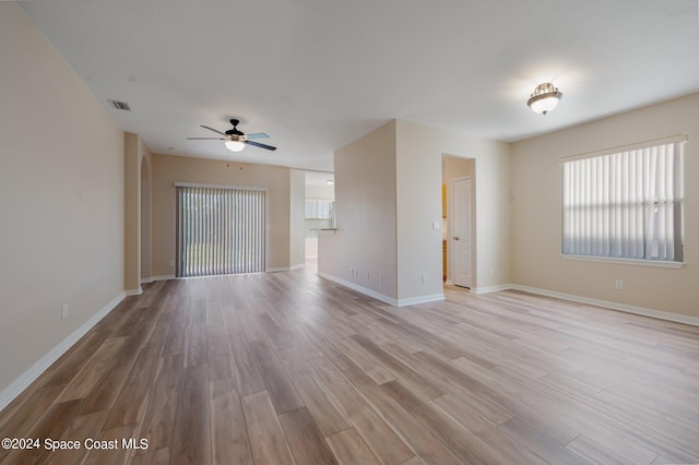 unfurnished living room with light hardwood / wood-style flooring and ceiling fan