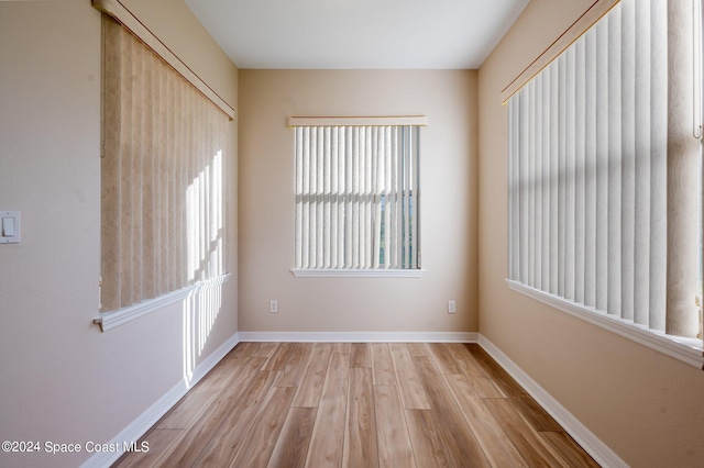 spare room with light hardwood / wood-style flooring