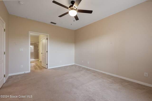 unfurnished bedroom featuring ceiling fan and light carpet