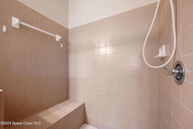 bathroom with a tile shower