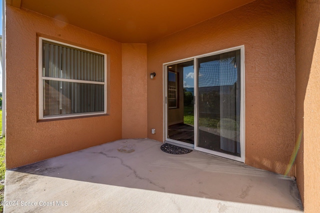 doorway to property featuring a patio area