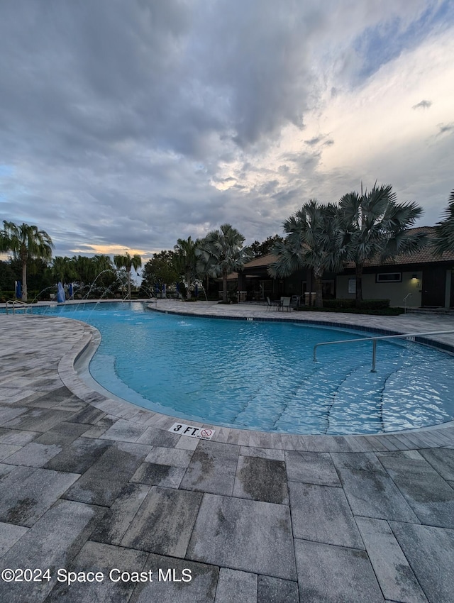 view of pool with pool water feature and a patio area