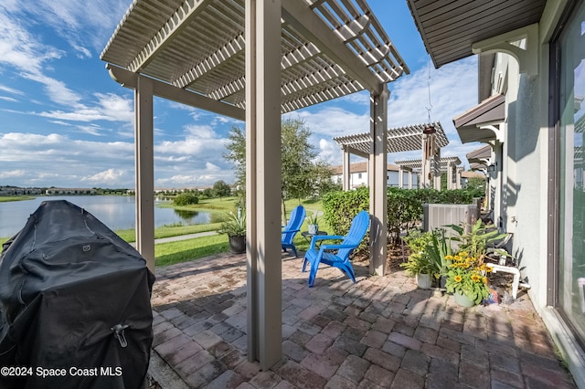 view of patio featuring a water view, area for grilling, and a pergola