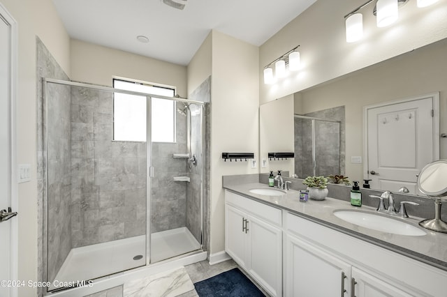 bathroom featuring vanity and a shower with shower door