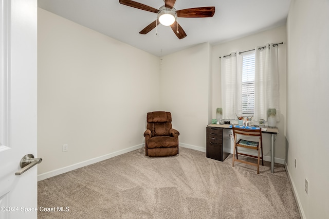 living area with light colored carpet and ceiling fan