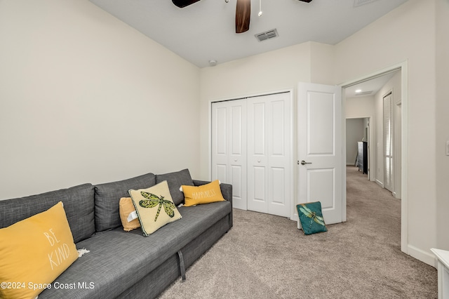 carpeted living room featuring ceiling fan