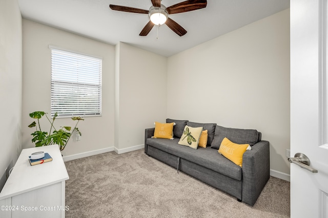 carpeted living room with ceiling fan