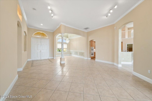 tiled foyer entrance with ornamental molding and rail lighting