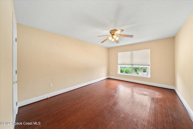 empty room featuring ceiling fan, hardwood / wood-style flooring, and a textured ceiling