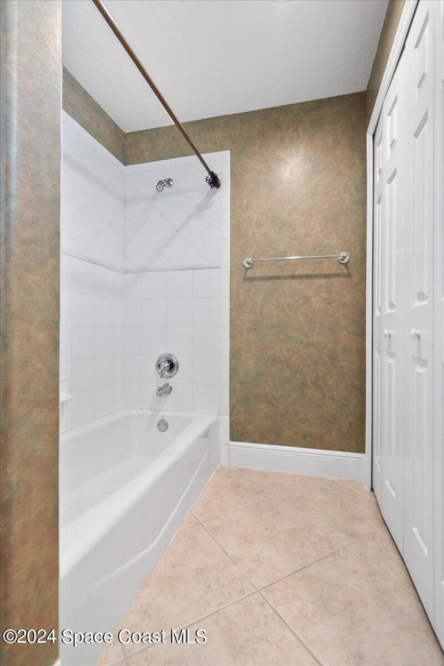 bathroom with tiled shower / bath and tile patterned floors