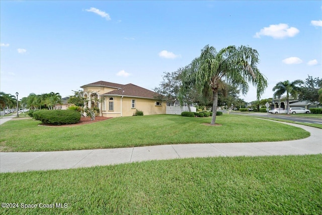 mediterranean / spanish house featuring a front lawn