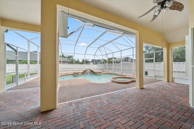 view of swimming pool with ceiling fan, a patio, glass enclosure, and an in ground hot tub