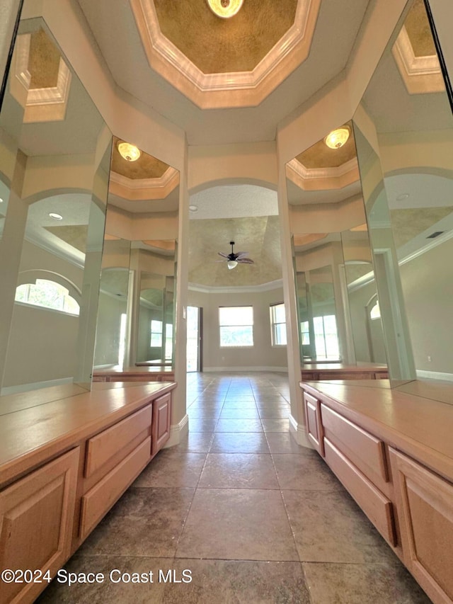 bathroom featuring crown molding, ceiling fan, and a raised ceiling