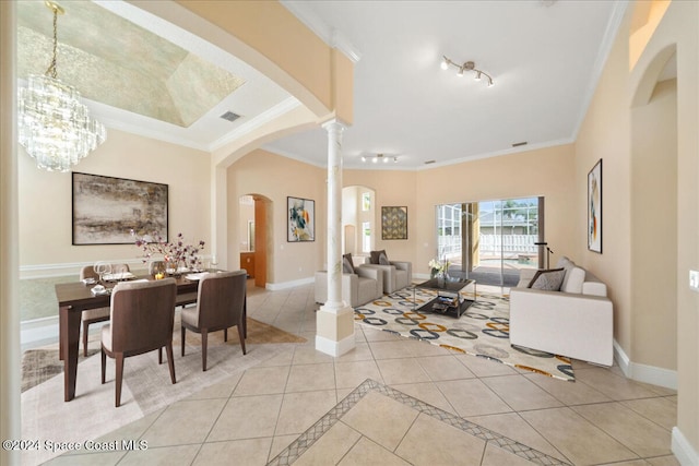 tiled living room with ornamental molding, ornate columns, and a chandelier