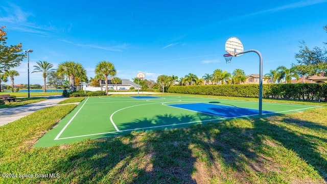 view of basketball court with a yard