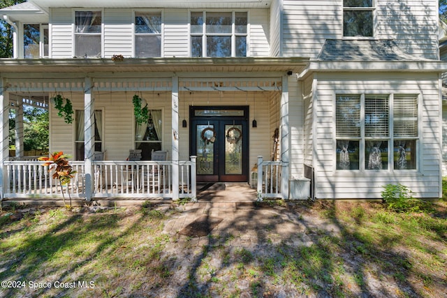 view of front of house featuring a porch and french doors