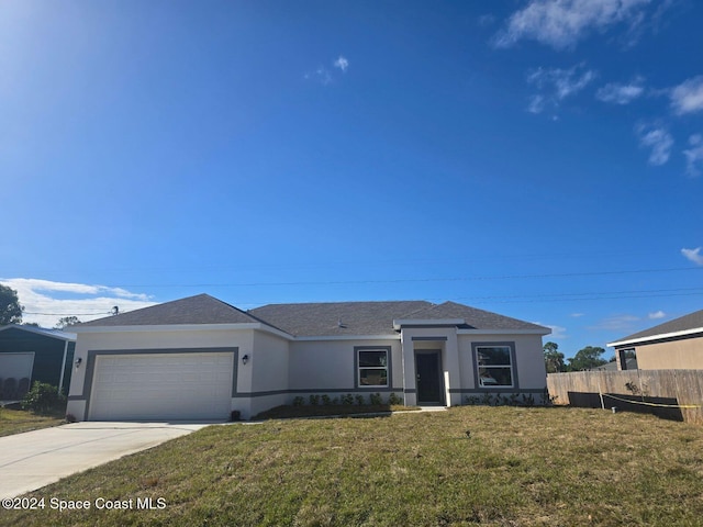 view of front facade with a garage and a front lawn