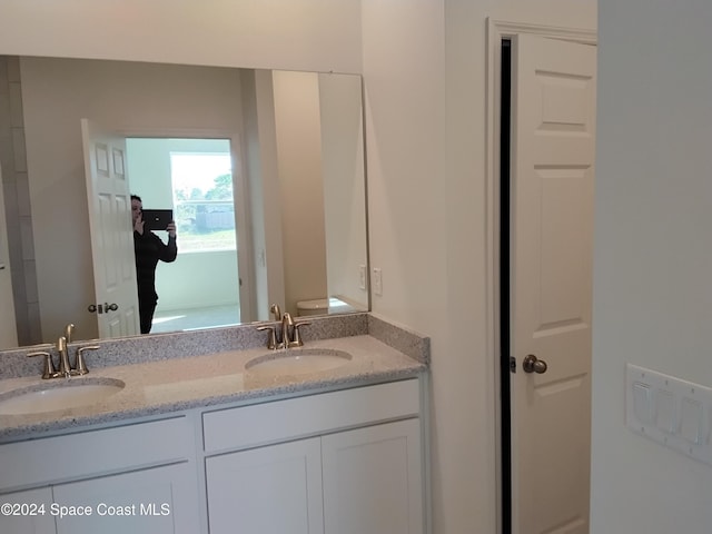 bathroom with vanity and toilet