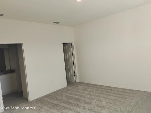 empty room with light colored carpet