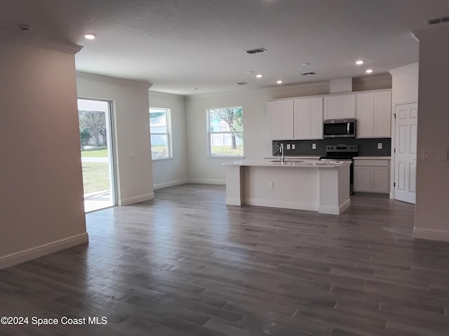 kitchen with white cabinets, electric stove, sink, dark hardwood / wood-style floors, and an island with sink