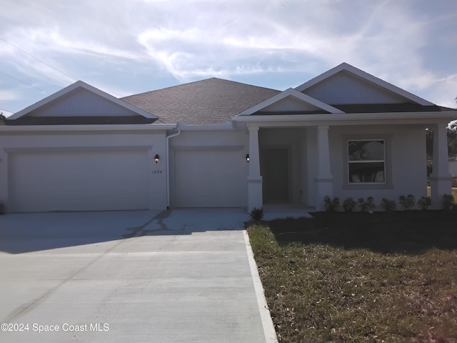 view of front of house featuring covered porch and a garage