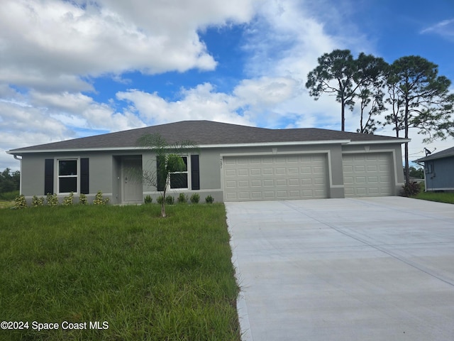 ranch-style house with a garage and a front lawn