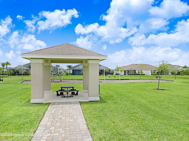 view of community featuring a residential view, a lawn, and a gazebo