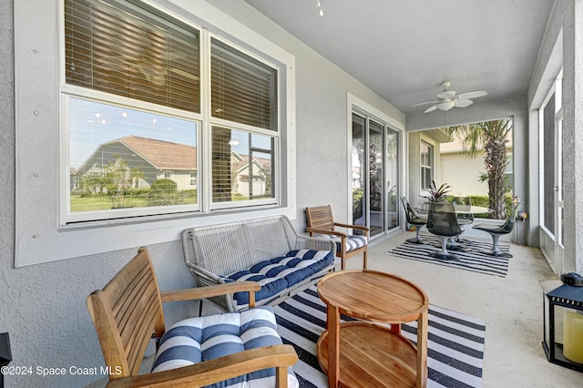 sunroom / solarium featuring ceiling fan