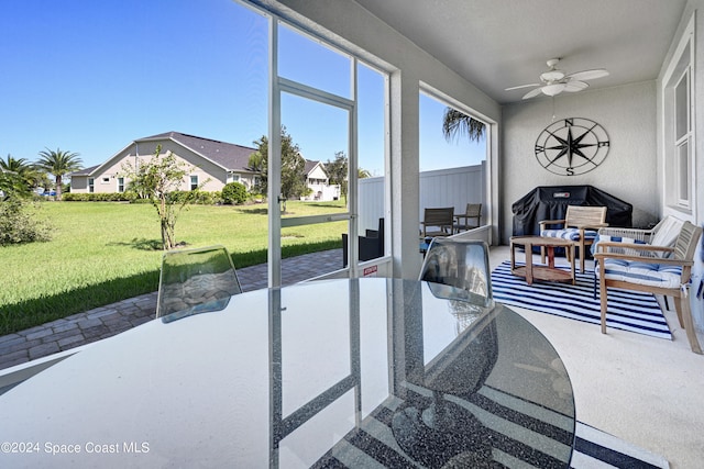 sunroom featuring ceiling fan