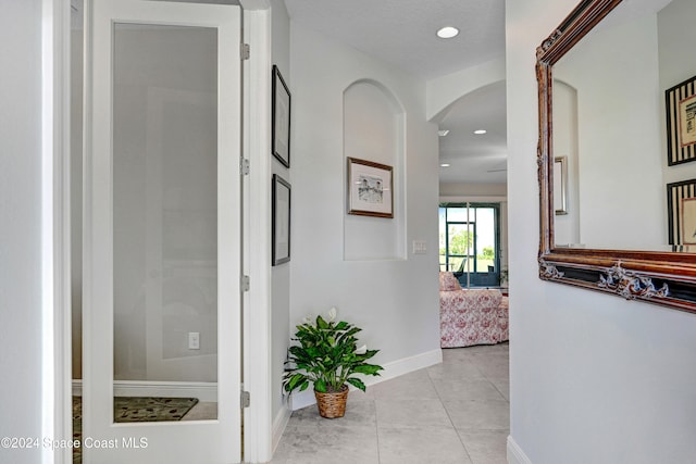 corridor with light tile patterned flooring