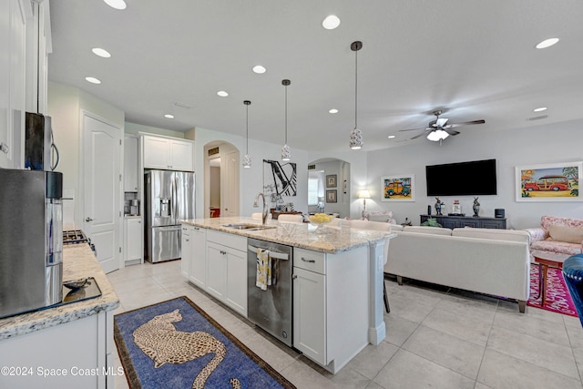 kitchen featuring appliances with stainless steel finishes, pendant lighting, sink, and white cabinets