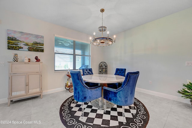 tiled dining area with a chandelier