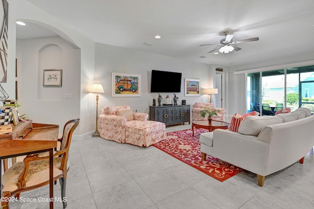 tiled living room with ceiling fan