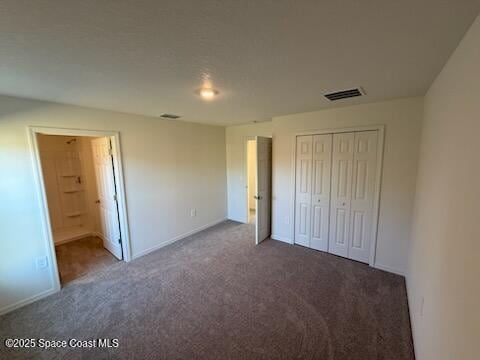 unfurnished bedroom with carpet floors and a closet