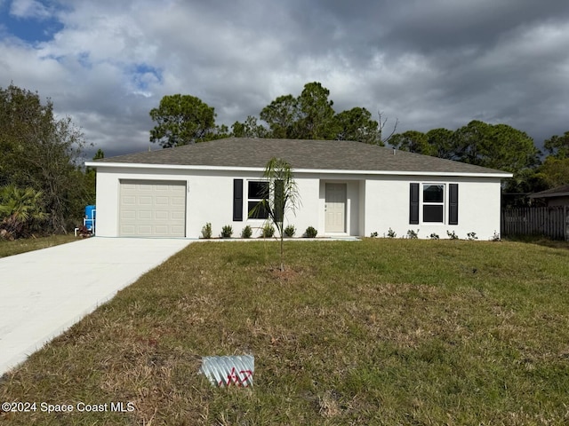 single story home with a front lawn and a garage