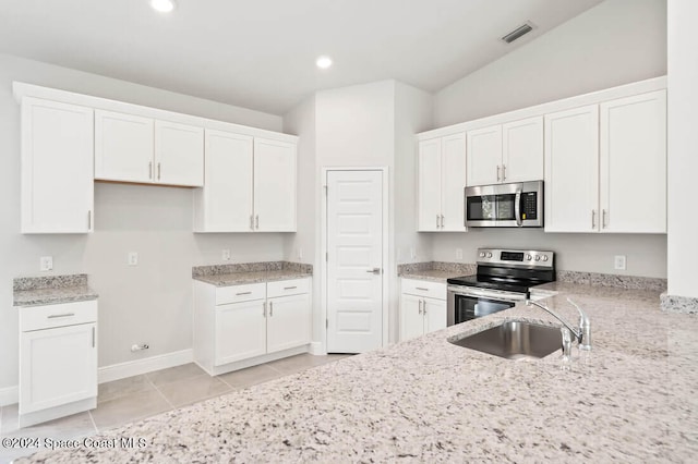 kitchen featuring appliances with stainless steel finishes, white cabinetry, and sink