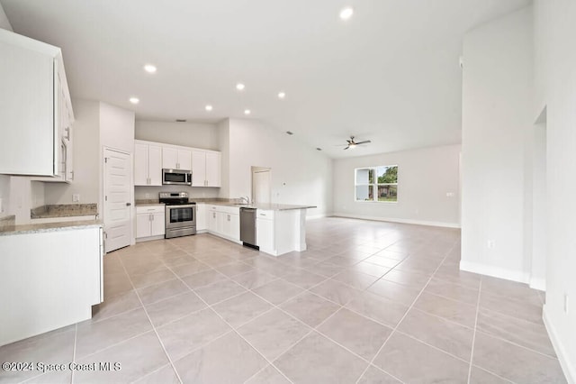 kitchen featuring ceiling fan, white cabinets, light tile patterned flooring, and appliances with stainless steel finishes