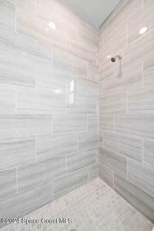 bathroom with tiled shower