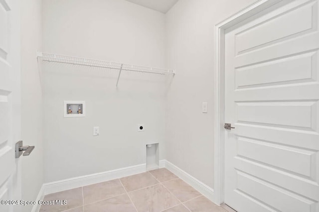 laundry area with hookup for an electric dryer, light tile patterned flooring, and washer hookup