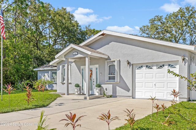 view of front facade with a front yard and a garage