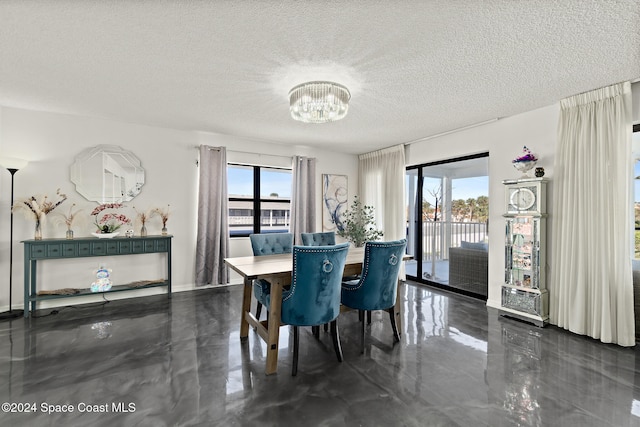 dining area featuring an inviting chandelier and a textured ceiling