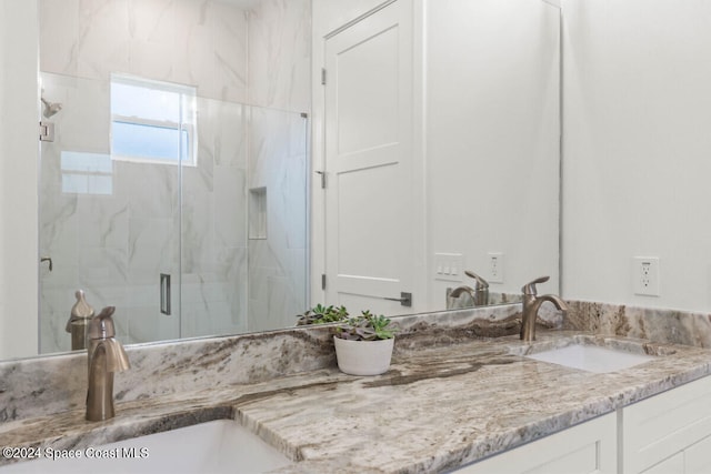 bathroom with an enclosed shower and vanity