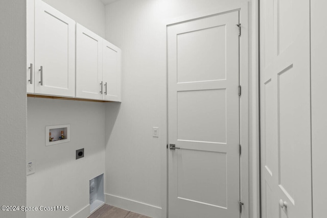 laundry room with washer hookup, cabinets, light hardwood / wood-style floors, and electric dryer hookup