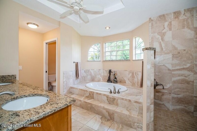 full bathroom with vanity, separate shower and tub, toilet, and ceiling fan