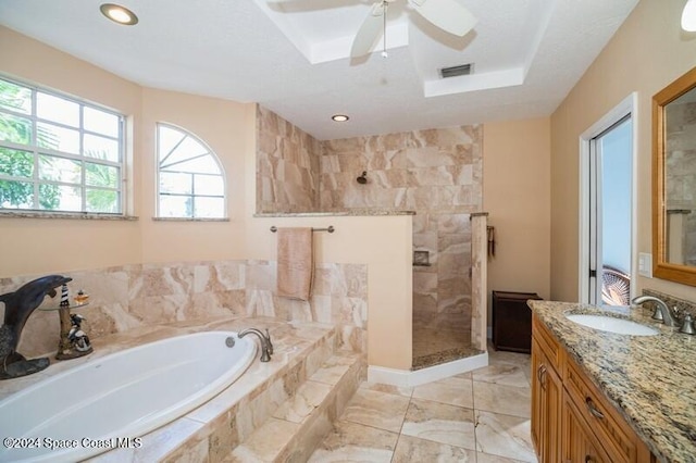 bathroom featuring vanity, plus walk in shower, and ceiling fan