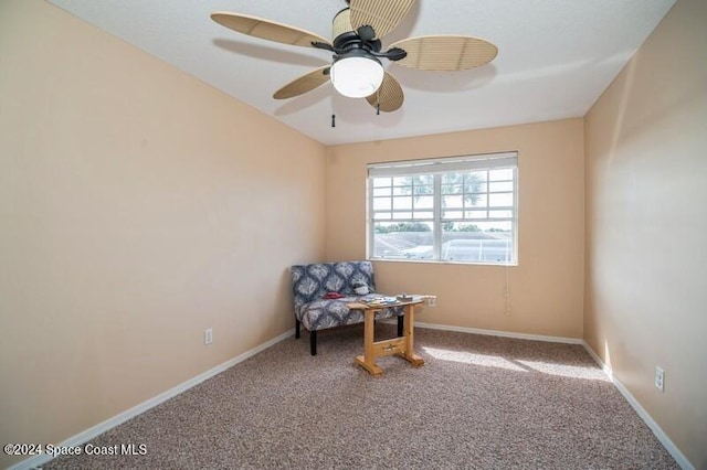 living area with carpet floors and ceiling fan