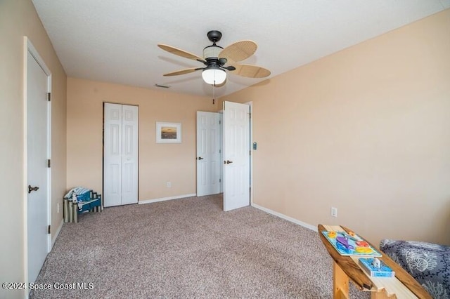 unfurnished bedroom with a closet, carpet flooring, and ceiling fan