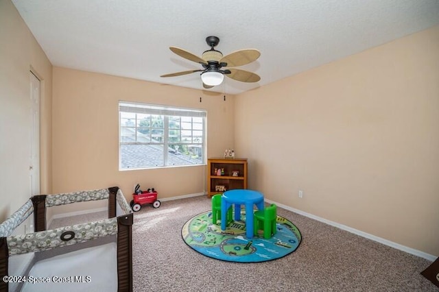 recreation room featuring carpet and ceiling fan