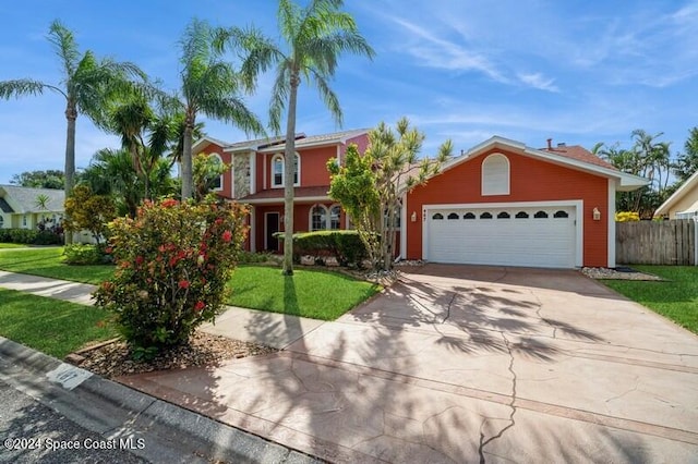 view of front of home featuring a front yard and a garage